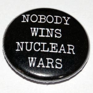 May include: Black and white button with the text "Nobody Wins Nuclear Wars".