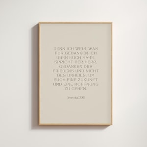 May include: A framed print with a light beige background and a wooden frame. The print features text in a dark grey colour. The text is a quote from Jeremiah 29:11. The overall aesthetic is minimalist and suitable for home decor.