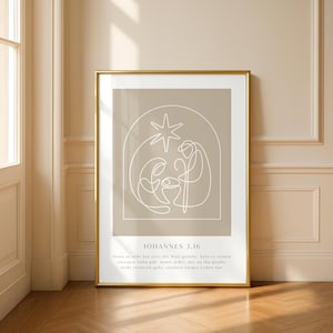 Könnte beinhalten: Ein gerahmter Kunstdruck mit einer minimalistischen Strichzeichnung der Geburtsszene in Weiß auf beigem Hintergrund. Der Druck ist in einem goldenen Rahmen und enthält den Text "JOHANNES 3.16" und einen deutschen Bibelvers.