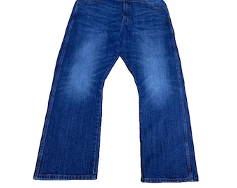 May include: Blue denim jeans with a classic five-pocket design. The jeans have a relaxed fit and a slightly flared leg. The denim has a medium wash with some fading and whiskering. The jeans are a size 42x30.