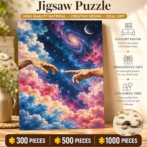 May include: A jigsaw puzzle featuring a celestial scene with two hands reaching toward each other against a backdrop of pink and blue clouds, a spiral galaxy, and a crescent moon. The text Jigsaw Puzzle is at the top, with 300, 500, and 1000 pieces options listed at the bottom.