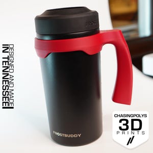 May include: Black travel mug with a red handle and accents. The mug has a black lid and the text "FROSTBUDDY" is printed on the bottom. The mug is designed and made in Tennessee.
