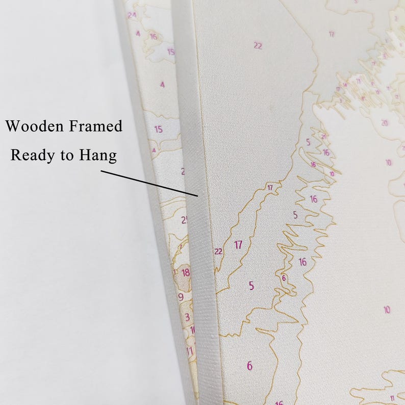 May include: Close-up of a wooden framed canvas with a paint-by-numbers design. The canvas is ready to hang and features a numbered map-like pattern in shades of beige, brown, and red. The text "Wooden Framed Ready to Hang" is visible.