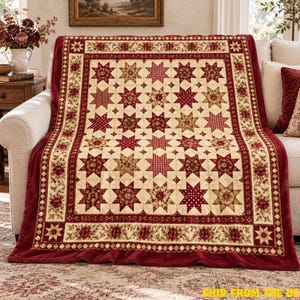 May include: A plush throw blanket featuring a repeating star pattern in shades of deep red, cream, and tan. The center displays a grid of multi-patterned stars, while the border showcases a floral vine motif and a diamond-shaped trim.