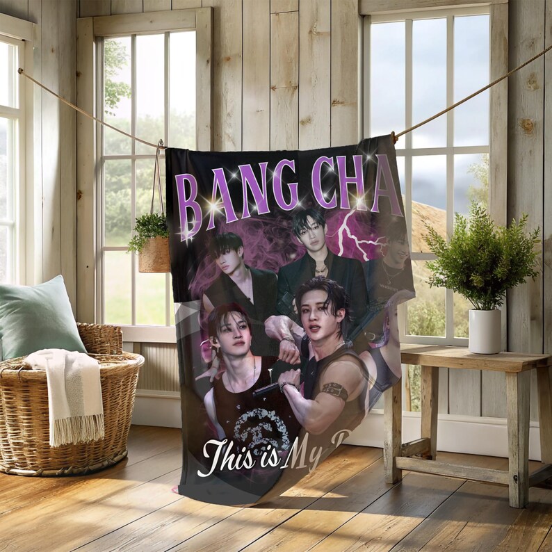 May include: Black blanket with a photo collage design featuring a group of people and the text "BANG CHA" in purple. The blanket also has the text "This is My". The background includes purple lightning bolts.