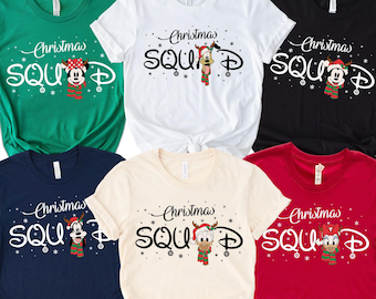 May include: A collection of six short-sleeve t-shirts in green, white, black, navy, cream, and red. Each shirt features the text Christmas SQUAD with a Disney character wearing a holiday hat and scarf, surrounded by small snowflake graphics.