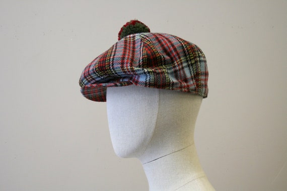 flat hat with a pom pom