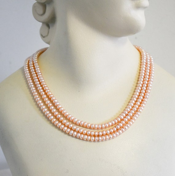 Vintage Peachy-Pink Faux Pearl Three Strand Neckl… - image 1