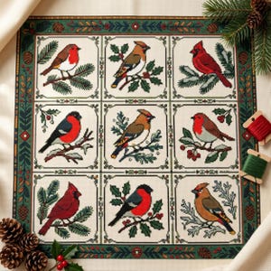 May include: A square needlepoint canvas featuring a grid of nine individual panels, each depicting a different bird perched on a branch. The border is decorated with a green, red, and brown pinecone and holly leaf pattern. Two spools of thread are visible.