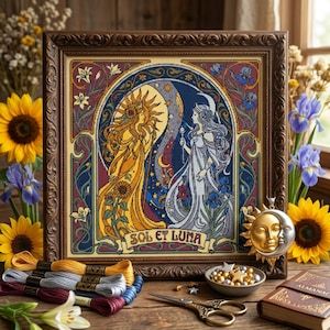 May include: A framed cross-stitch embroidery depicting a sun deity in yellow and a moon deity in blue, with the text SOL ET LUNA. The artwork features intricate floral borders, accompanied by embroidery floss, a metal sun and moon charm, and scissors.