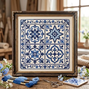 May include: A square cross-stitch embroidery featuring four distinct blue and white geometric tile patterns arranged in a grid, enclosed by a decorative floral border, all housed within a dark brown ornate wooden frame.