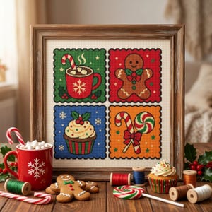 May include: A framed cross-stitch embroidery featuring four square panels with Christmas motifs: a red mug with a candy cane, a gingerbread person, a cupcake, and candy canes. The design is displayed on a wooden table with matching physical items.
