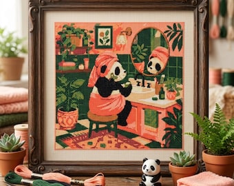 May include: A framed cross-stitch embroidery depicting a panda wearing a peach-colored towel on its head and body, sitting on a stool in a bathroom with green tiled walls, a sink, a mirror, and various potted plants, rendered in a pixelated style.