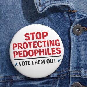May include: A white badge with the red text "STOP PROTECTING PEDOPHILES" and "VOTE THEM OUT" with blue stars, set against a blue denim jacket.