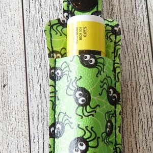 LIP BALM Holder, pouch, key fob, Key Chain, keychain, Balm holder.  Green background, white spider webs and SPIDERS! Clip on purse or tote.
