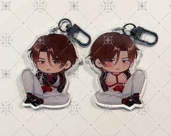 May include: Two acrylic keychains featuring a chibi-style character with brown hair, wearing white pants and a red harness. Each charm is attached to a black lobster clasp. The character is depicted in a seated position with a serious expression.