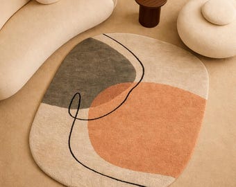 Alfombra redonda orgánica con mechones en beige y terracota, hecha a mano en lana para una decoración moderna de salón.
