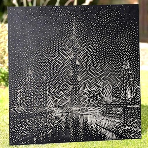 May include: A square black panel featuring a pointillist-style city skyline illustration created with numerous white dots. The dense arrangement of dots forms the silhouettes of tall buildings and structures against a dark background.