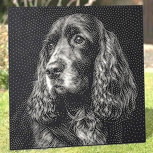 May include: A square black metal panel featuring a stippled portrait of a dog. The image is created using numerous small white dots of varying density against the solid black background to define the facial features, eyes, and floppy ears.