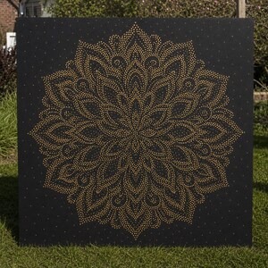 May include: A square black canvas featuring a large, intricate mandala design composed of numerous small, metallic gold dots. The symmetrical pattern radiates from the center, with concentric layers of petal-like shapes and fine golden points.