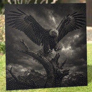 May include: A square black metal panel featuring a perforated design that creates a high-contrast image of a bird in flight. The artwork is composed of numerous small circular holes of varying sizes, allowing light to pass through the dark surface.