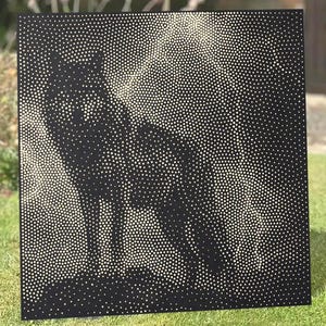May include: A square black metal panel featuring a stippled design of a wolf. The image is created using numerous small, circular perforations of varying sizes that allow light to pass through, forming the silhouette of the animal.