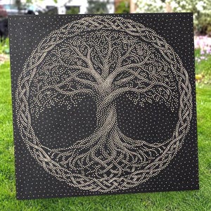 May include: A square black wall art piece featuring a tree of life design created with small white dots. The tree is enclosed within a circular border of intricate, braided knotwork patterns, all rendered in a pointillist style against the dark background.