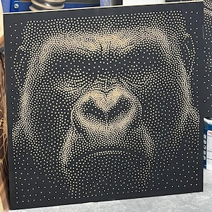 May include: A square black canvas featuring a design made from small, evenly spaced, light-coloured dots. The dots create the shape of a heart. This artwork is a unique piece of wall decor.