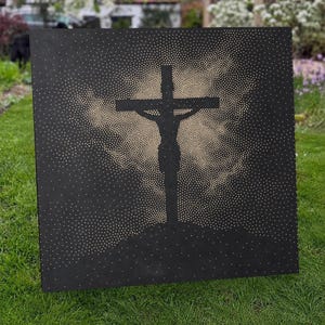 May include: A square black panel featuring a central silhouette of a crucifix. The design is created using numerous small, light-colored dots that form a radiant, cloud-like pattern surrounding the cross against the solid dark background.