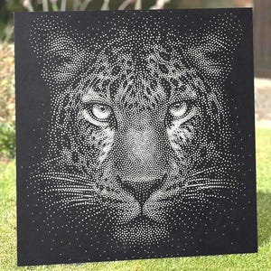 May include: A square black panel featuring a pointillist-style portrait of a leopard face created with white dots. The design highlights the feline's intense eyes, spotted fur pattern, and whiskers, all rendered through a dense arrangement of dots.