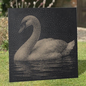 May include: A square black wall art piece featuring a swan silhouette created with a dense pattern of small gold dots. The design depicts the swan in profile with a reflection on the water surface, all rendered in a pointillist style on a dark background.