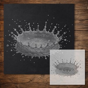 May include: A square black stencil featuring a white dot-matrix pattern that depicts a liquid splash or crown shape. The design consists of numerous small white dots arranged to form a central circular splash with radiating droplets.