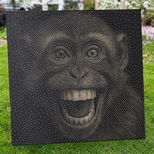 May include: A square black wall art piece featuring a pointillist portrait of a chimpanzee created with numerous small, light-colored dots. The dots vary in density to form the facial features, eyes, and an open-mouthed expression of the primate.