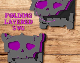 May include: A digital graphic design file featuring a folding layered SVG of a grey, cracked skull-like creature with vibrant purple accents. The text FOLDING LAYERED SVG is displayed in purple on the left side of the image.