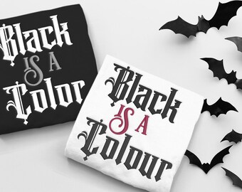 May include: Two t-shirts with the text "Black is a Color" in a gothic font. The shirt on the left is black with white text. The shirt on the right is white with black text and a red "is".