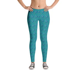 May include: Teal leggings with a repeating pattern of blue and red crossed lines.