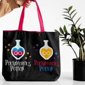 May include: A black tote bag with pink handles features two illustrations of potion bottles with hearts containing infinity symbols. The text "Polyamorous Potion" is printed on the bag.