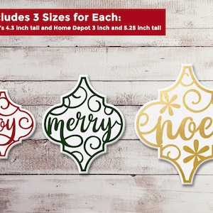 May include: Three Christmas baubles with a white background and intricate designs. The baubles are in the shape of a quatrefoil and feature the words "joy", "merry", and "noel" in a decorative script. The baubles are available in three sizes: 4.3 inches, 3 inches, and 5.25 inches.