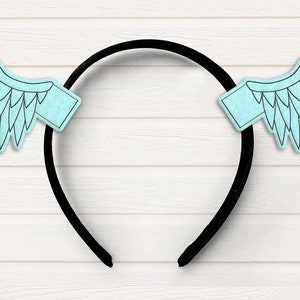 May include: A black headband with two light blue wings attached. The wings have a feather design.