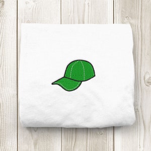 May include: A white t-shirt with a green embroidered baseball cap.