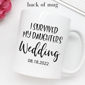 May include: White ceramic mug with black text that reads "I survived my daughter's wedding 08.18.2022".