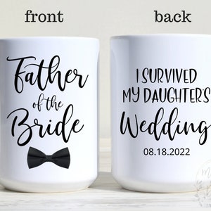 May include: White ceramic coffee mug with black text that reads "Father of the Bride" on the front and a black bow tie. The back of the mug reads "I survived my daughter's wedding 08.18.2022".