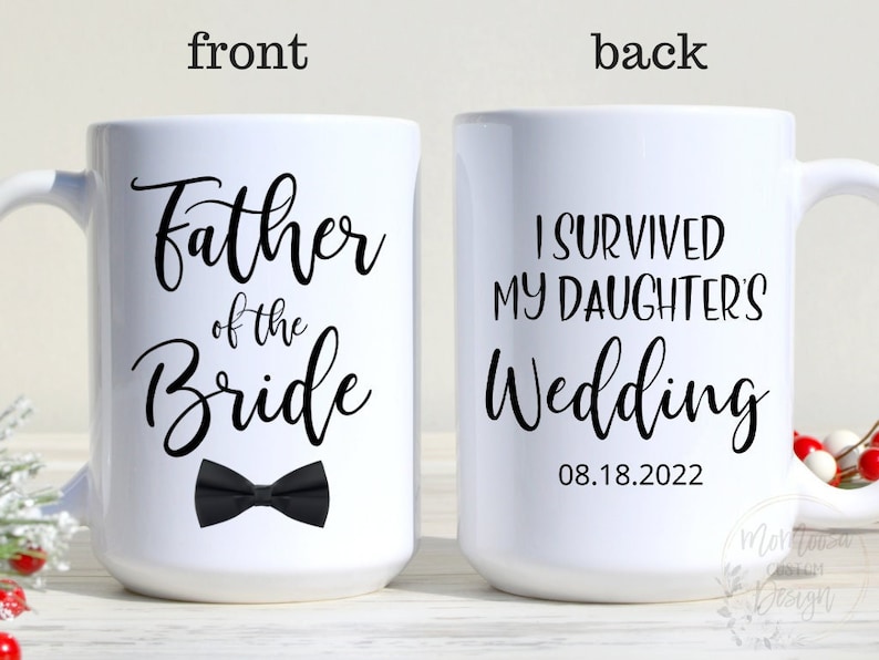 May include: White ceramic coffee mug with black text that reads "Father of the Bride" and a black bow tie. The back of the mug reads "I survived my daughter's wedding 08.18.2022".