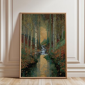 May include: Framed art print showing a tranquil forest scene. A stream meanders through birch trees with autumnal leaves. The artwork has a golden, patterned backdrop and is presented in a wooden frame.