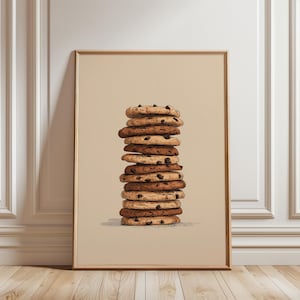 May include: A framed vertical wall art print featuring a centered illustration of a tall, precarious stack of twelve round chocolate chip cookies. The cookies are rendered in varying shades of tan and brown, set against a solid beige background.