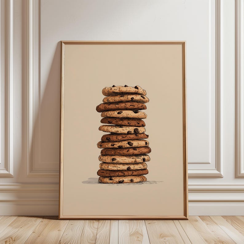 May include: A framed vertical wall art print featuring a centered illustration of a tall, precarious stack of twelve round chocolate chip cookies. The cookies are rendered in varying shades of tan and brown, set against a solid beige background.