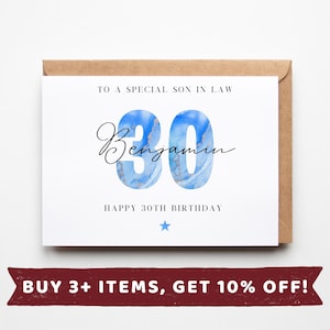 May include: A white birthday card with a brown envelope. The card says "TO A SPECIAL SON IN LAW" and "HAPPY 30TH BIRTHDAY". The number "30" is in blue with a marble design, and the name "Benjamin" is written in cursive. A blue star is at the bottom.