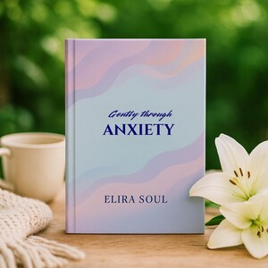 May include: A book titled "Gently through Anxiety" with a pastel design. The cover features the text in dark blue, with the author's name, "Elira Soul," at the bottom. A white lily and a mug are in the background.