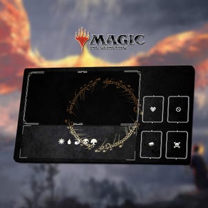 May include: Black playmat for Magic: The Gathering, featuring a gold ring inscription and card symbols. The mat has a rectangular design with a white border and the Magic: The Gathering logo in the upper right corner.