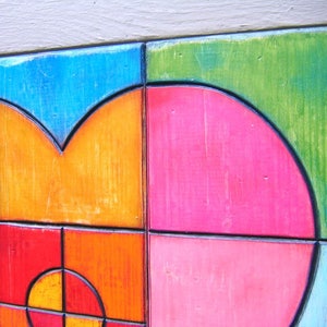 May include: A colorful abstract art piece with geometric shapes and a mix of orange, pink, blue, and green colors.